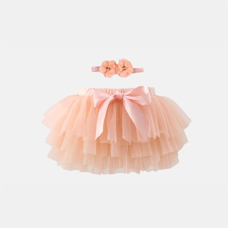 Playful Apricot Tutu Skirt from Dear Pastel. With an endearing headband, the incredibly soft tulle ensures your baby's comfort throughout.