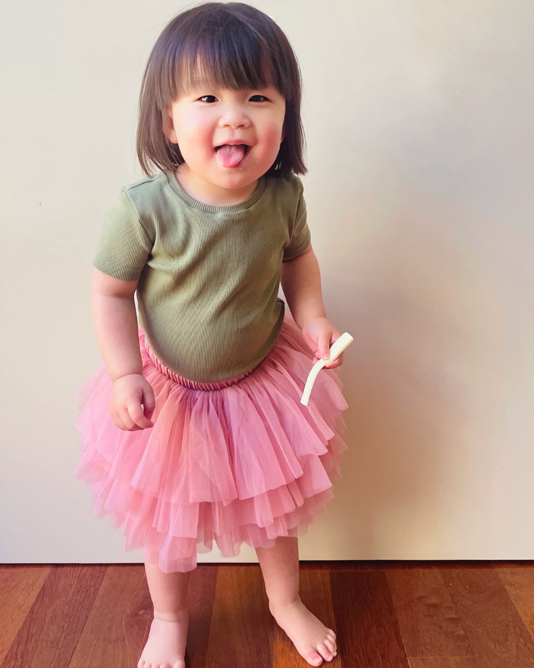Adorable baby girl modeling our Pale Rose Tutu Skirt. Soft and whimsical toddler fashion for special occasions, play, and more.